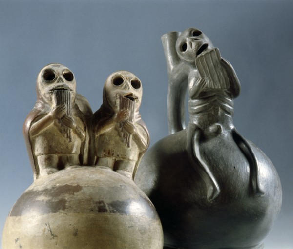 Two stirrup spouted Mochica jars depicting skeletal figures playing typically Andean pan pipes