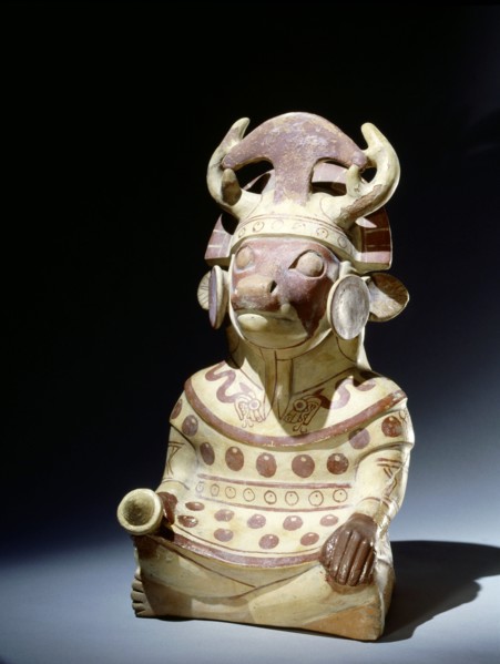 Deer headed anthropomorphic figure with elaborate headdress incorporating an inverted tumi knife