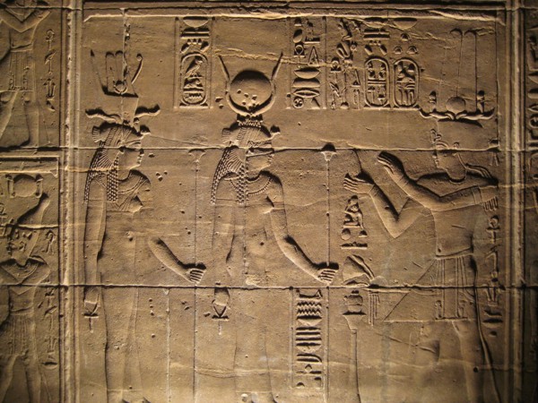 Relief depicting a pharaoh making offerings to the goddesses Isis and Hathor