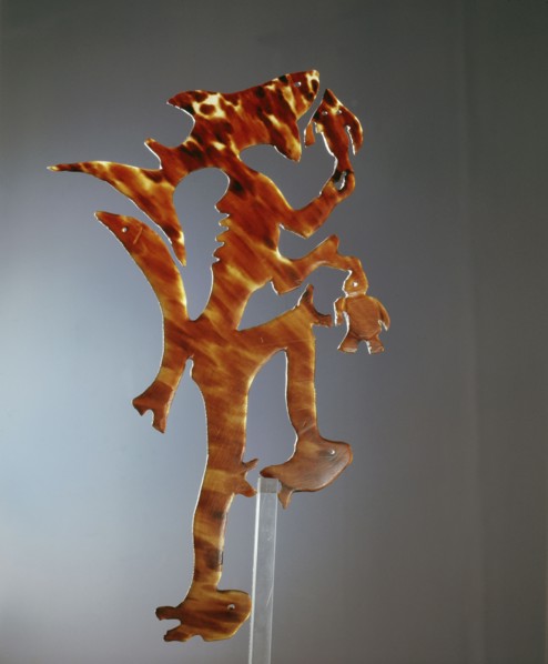 A complex tortoise shell low relief carving thought to represent a sea spirit
