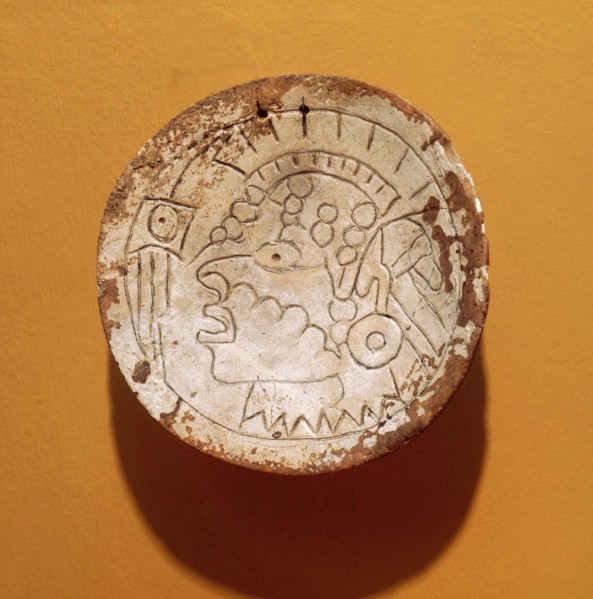 Shell gorget incised with a man with a Southern Cult headdress and ear plugs