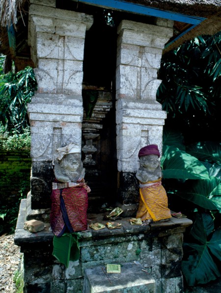 Divine gatekeepers at a small family temple dressed for a festival