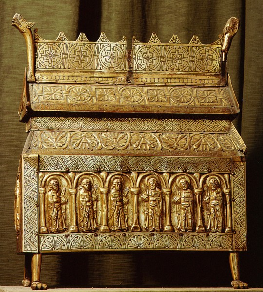 Brass reliquary with incised decoration and repousse panels depicting saints