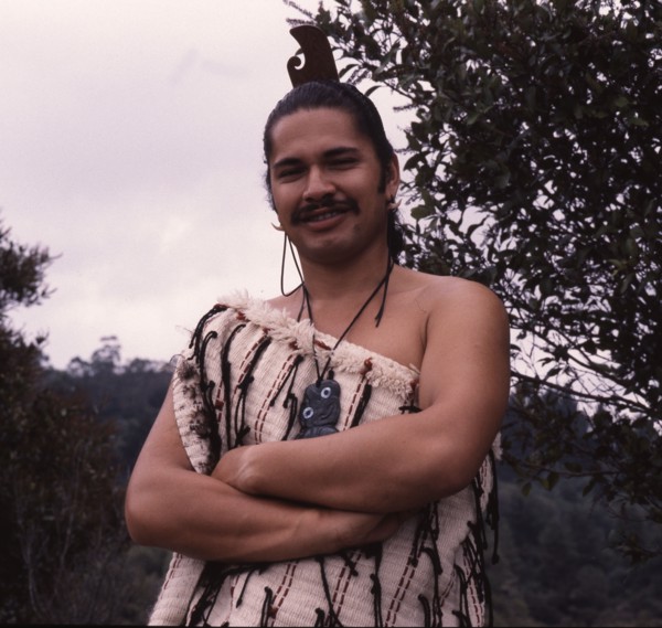 A Maori man wearing traditional dress and a hei-tiki pendant