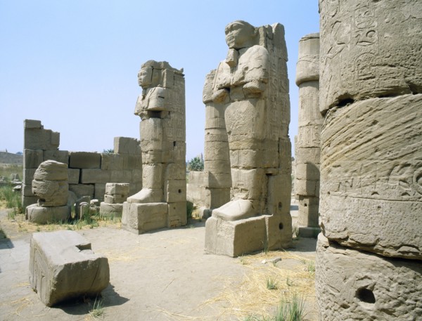 Two statues in the entrance of a corridor