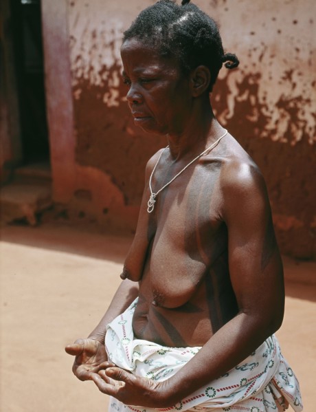 The wife of a Benin chief displays her body decorations