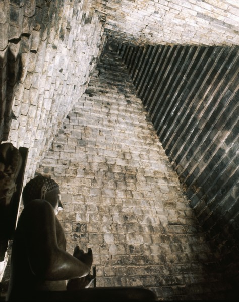A statue of the seated Buddha in Chandi Mendut, one of the several temples associated with Borobudur