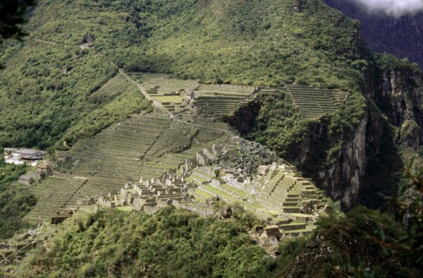 View of Machu Picchu from the summit of Huayna Picchu, showing the dramatic location of the city and its terrace system