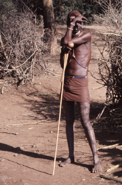 The hairstyle and beadwork of this Masai man indicate his status as a warrior