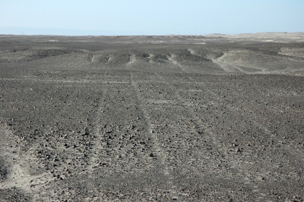 Parallel Nazca lines converging on / radiating out of a small hill