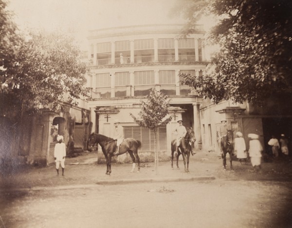 Saddling up outside a colonial house