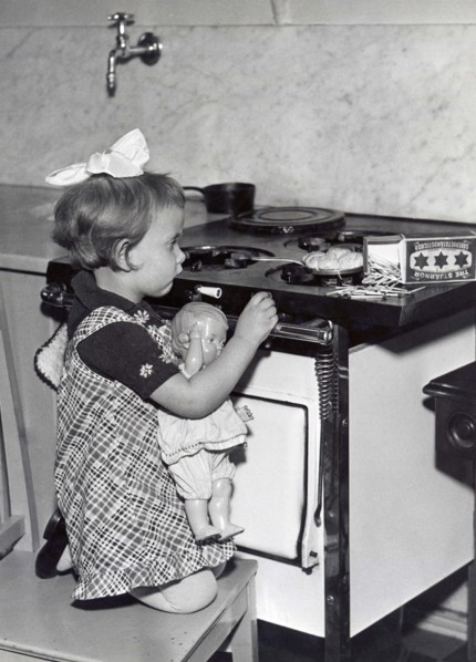 Girl And Doll In Kitchen