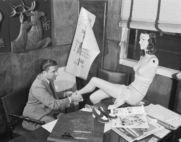 Man Adjusting A Mannequin