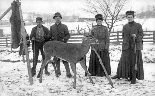 Four hunters and their game.