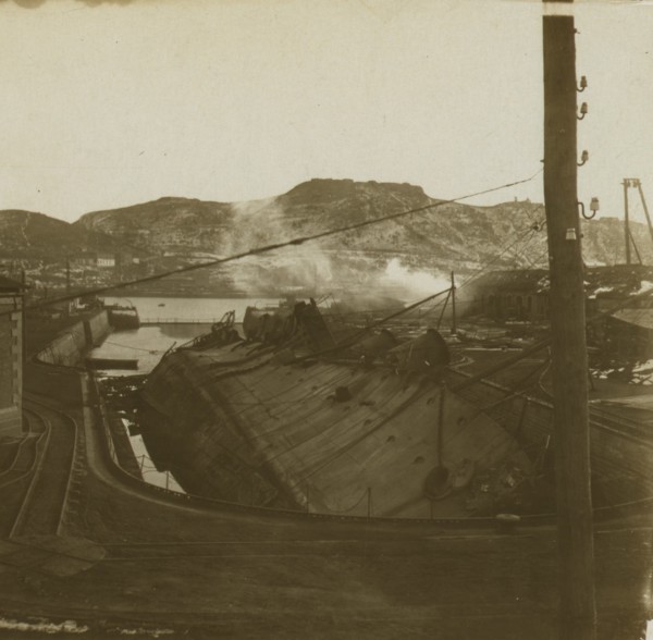 A warship on its side at a quay, Port Arthur 1905