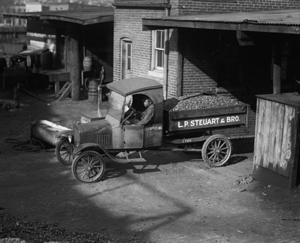 African American Driver has a load of coal ready for delivery the company truck 1923