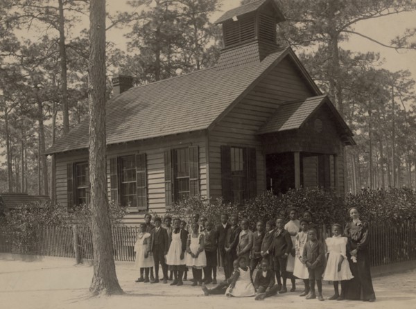 African American school children posed with their teacher outside a school, possibly in South Carolina 1905