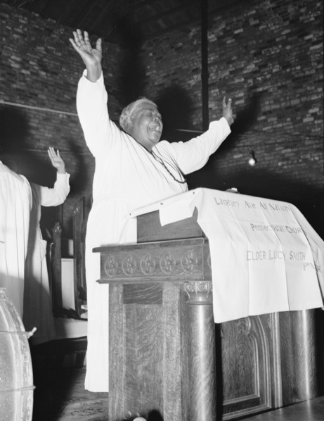 African American Woman Pastor leads her congregation in Prayer 1939