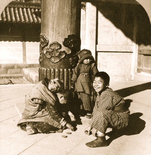 Children playing at the entrance to the temple, Nagoya, Japan 1902