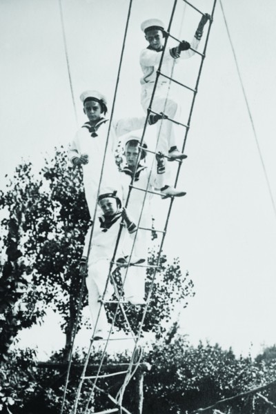 Crown Prince of Germany's Children frolic on what appears to be a ship's ratline or rope ladder