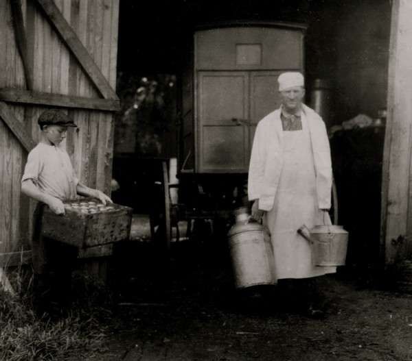 Loading Mill and other Dairy products from the farm into the wagon driven by a young man 1916