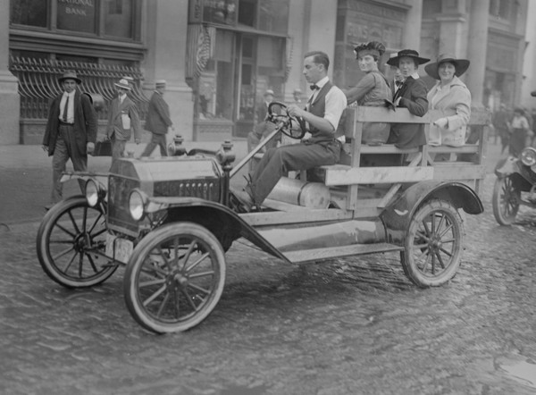 New York Car Strike has women transported to work in an open sided male driven vehicle 1916