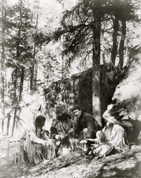 Ernest Thompson Seton, with three Blackfeet Indians, demonstrating how to start a fire 1917