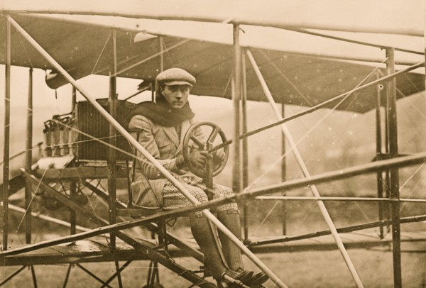 F.L. de Riemsdyk at pilot wheel of Curtiss aeroplane 1909