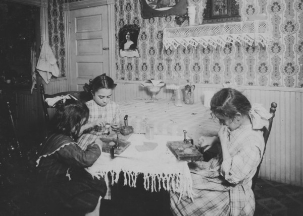 Girls working on ice wagon and delivering it in bags or sacks to homes 1912