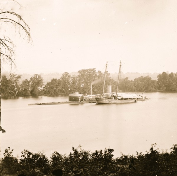 James River, Virginia. U.S. monitor CANONICUS taking on coal from a schooner 1864