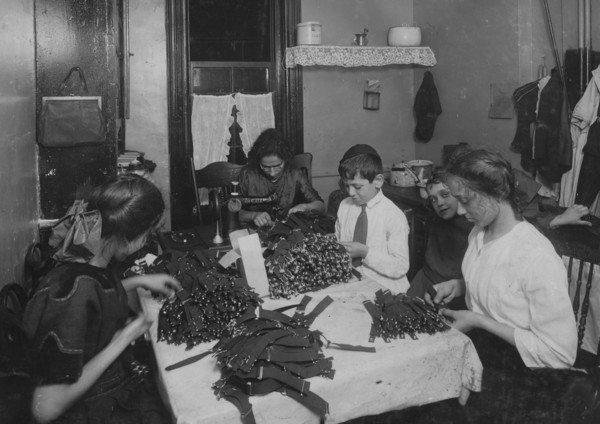Jewish family working on garters in kitchen for tenement home 1912
