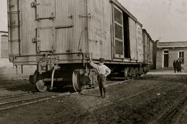 Boy beside a boxcar at the Mill 1908