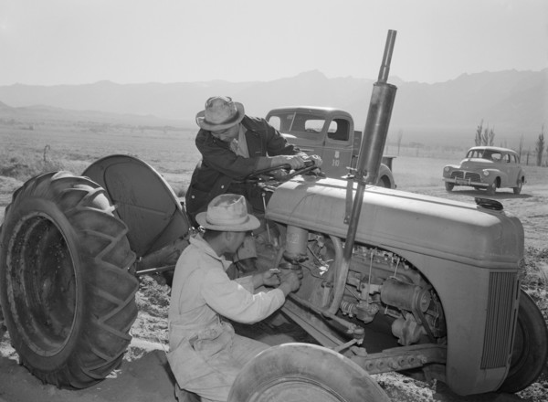 Tractor repair: Driver Benji Iguchi, Mechanic Henry Hanawa, Manzanar Relocation Center, California 1943