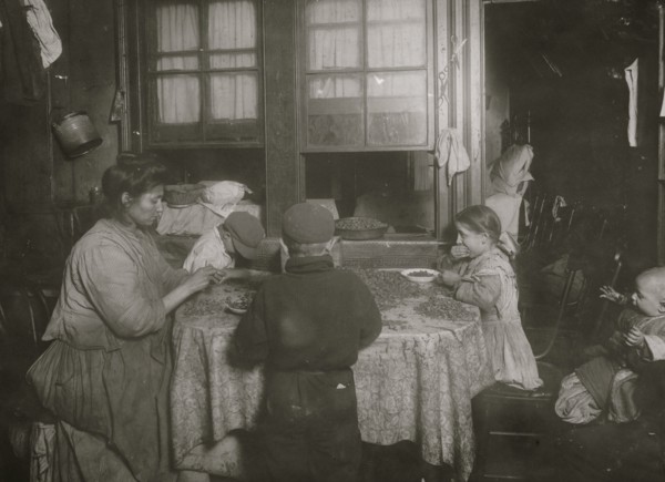 Italian family packing nuts in their tenement apartment 1911