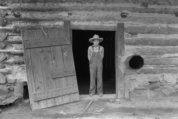 Farm boy in doorway of tobacco barn 1939