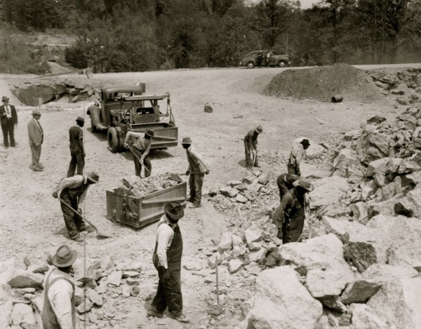 Prisoners breaking up rocks at a prison camp or road construction site 1941