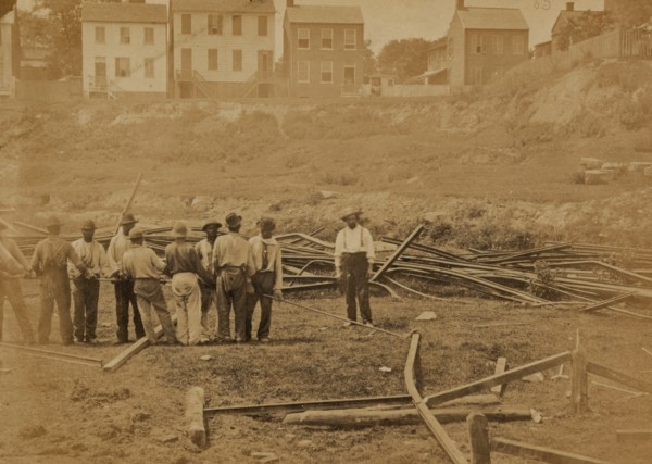Railroad construction workers straightening track 1863