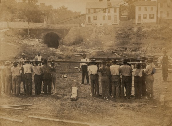 Railroad construction workers straightening track 1863