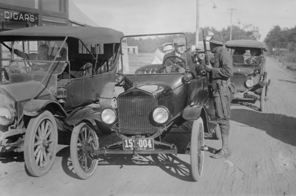 Soldier with Rifle confronts a vehicle with civilians