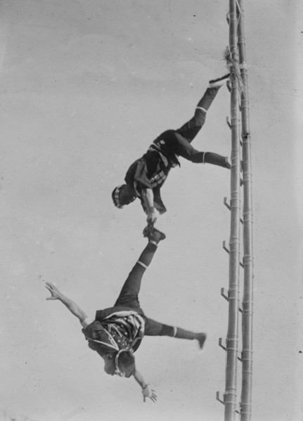 Two Tokyo Firefighters display acrobatic skill on very high bamboo ladders
