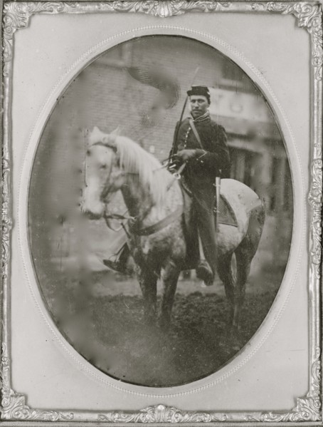 Unidentified African American soldier seated on horseback, facing left. 1865
