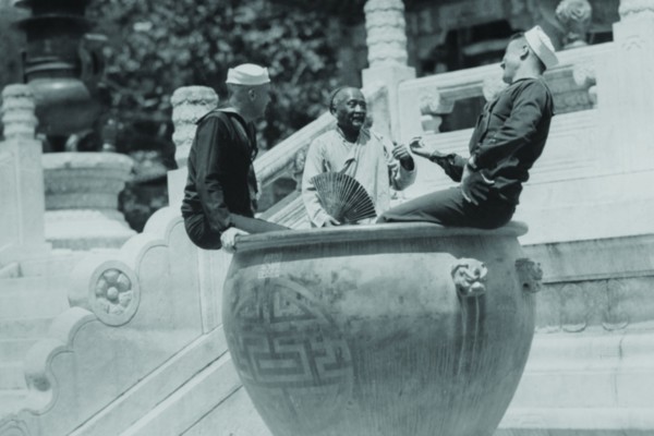 US Navy Sailors on Shore Leave in Beijing frolic in Giant Ceramic Pot with Guide