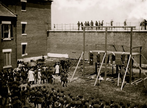 Washington, D.C. Hanging hooded bodies of the four conspirators; crowd departing 1865