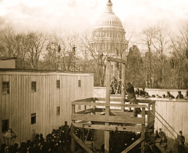Washington, D.C. Soldier springing the trap; men in trees and Capitol dome beyond 1865
