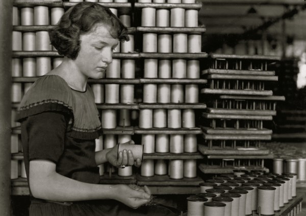 Young Girl stacks spools of silk thread 1924