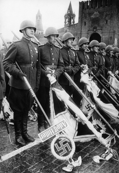 Red army soldiers holding nazi banners during ve day celebrations in red square in moscow at the end of world war 2, 1945.