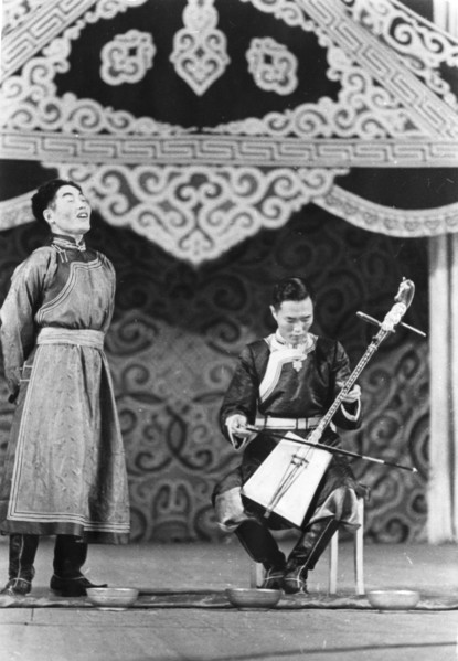 Mongolian folk singer dolgor zhab sings traditional song 'dumun', muru dorzhi accompanies him on horse head fiddle, moscow, ussr, september 1947.