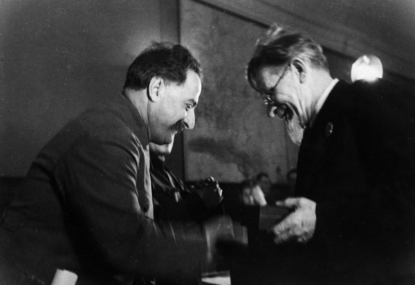 M, i, kalinin, president of the central executive committee of the ussr, awarding the order of the red banner of labor to grigoriy konstantinovich ordzhonikidze (sergo ordzhonikidze), the people's com...