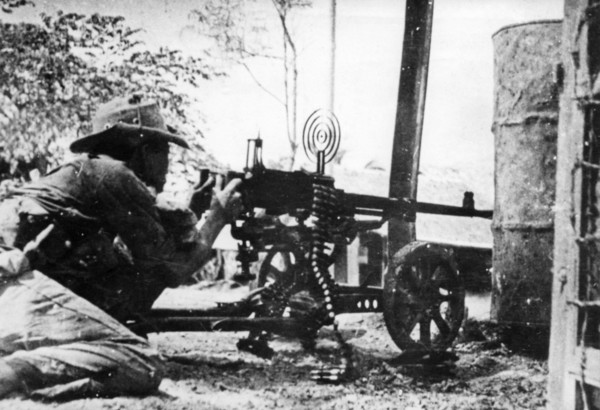 A nlf (national liberation front) fighter firing a machine gun at his post in sguemtri faun, in the village of mi tho, south vietnam, february 1969.