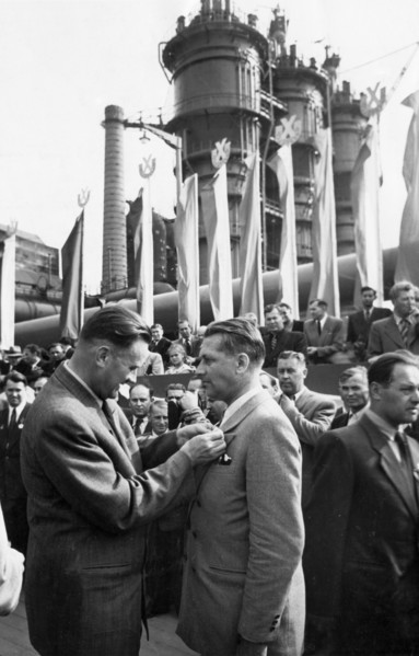 Piotr jaroszewicz, vice-chairman of the polish council of ministers, decorating engineer kiersnowski with the 'standard of labor' medal during the celebration of the opening of the big furnace at the ...
